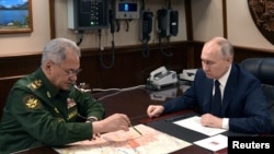 Rusya Savunma Bakanı Sergey Şoygu ve Rusya lideri Vladimir Putin